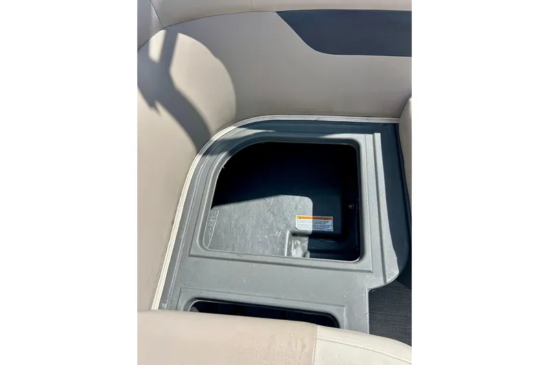Slide: The Image of Storage compartment in a 2019 Princecraft Vectra 21 boat, featuring beige seating. - 39