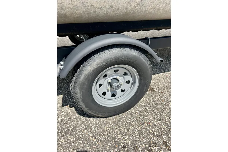 Slide: The Image of Trailer wheel of a 2019 Princecraft Vectra 21 boat on asphalt surface. - 54
