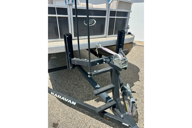 Slide: The Image of 2019 Princecraft Vectra 21 pontoon boat on Karavan trailer, parked on pavement. - 55