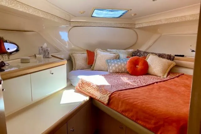 Slide: The Image of Cozy cabin interior of 1998 Carver 350 Mariner with plush bedding and natural light. - 11