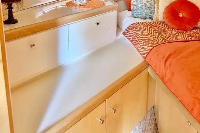 Slide: The Image of Interior of 1998 Carver 350 Mariner with cozy bedding and wooden cabinetry. - 12