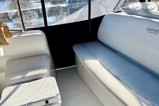 Slide: The Image of Interior of 1998 Carver 350 Mariner yacht with white seating and window views. - 15