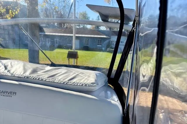 Slide: The Image of 1998 Carver 350 Mariner yacht interior with clear canopy and cushioned seating. - 18