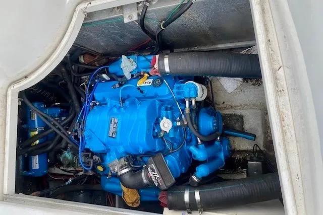 Slide: The Image of Engine compartment of a 1998 Carver 350 Mariner, featuring a blue marine engine. - 20