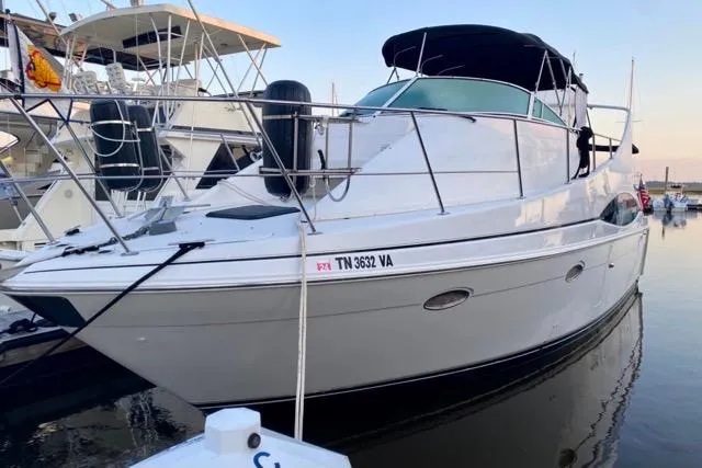 Slide: The Image of 1998 Carver 350 Mariner yacht docked at marina, featuring sleek design and spacious deck. - 3