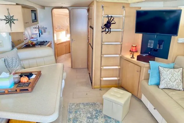 Slide: The Image of Interior of a 1998 Carver 350 Mariner yacht with cozy seating and modern amenities. - 8