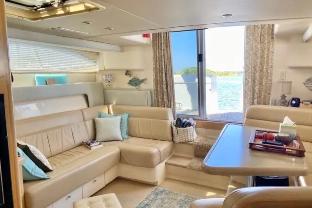 Slide: The Image of Interior of a 1998 Carver 350 Mariner yacht with beige seating and ocean view. - 9