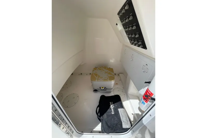 Slide: The Image of Interior of 2017 Everglades 243 Center Console boat with storage and control panel. - 13