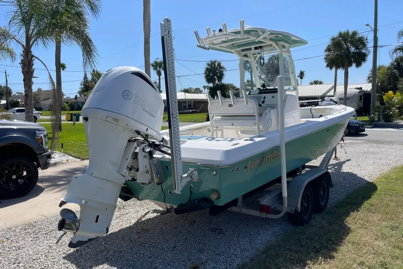 Slide: The Image of 2017 Everglades 243 Center Console boat on trailer, parked outdoors with palm trees. - 3