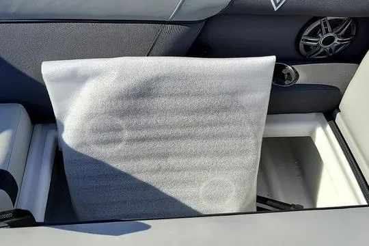 Slide: The Image of Interior of 2026 Viaggio X22S boat showing storage compartment and speaker. - 13