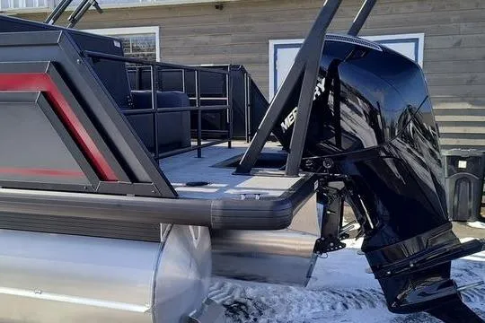 Slide: The Image of 2026 Viaggio X22S pontoon boat with Mercury outboard motor, docked on snowy surface. - 2