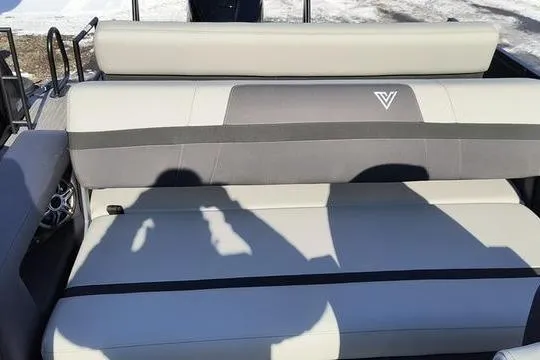 Slide: The Image of 2026 Viaggio X22S boat seat with gray upholstery and logo, outdoors in sunlight. - 9
