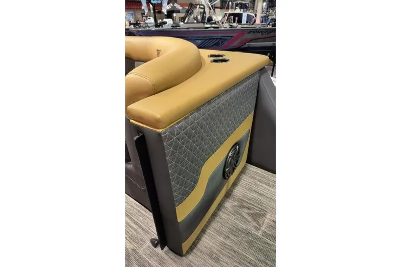 Slide: The Image of 2026 Viaggio Z22U boat interior with tan and gray upholstery, featuring cup holders and speaker. - 10