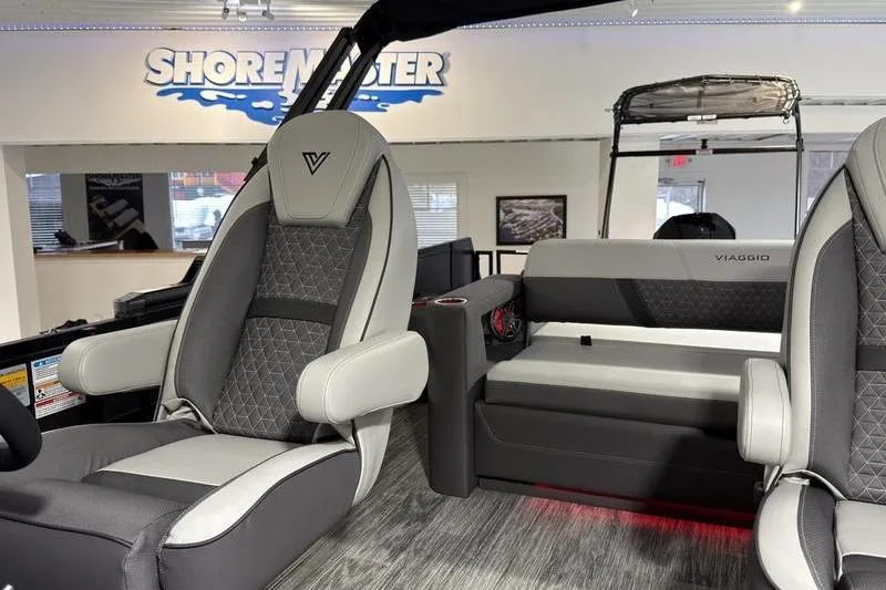 Slide: The Image of Interior of 2026 Viaggio Z22S boat with modern seating and ShoreMaster branding. - 16
