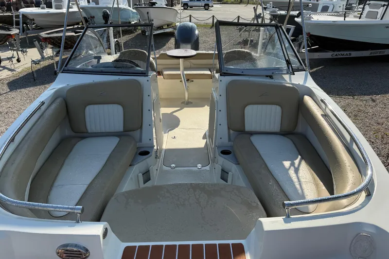 Slide: The Image of 2019 Stingray 201 DS boat interior with beige seating and windshield. - 16