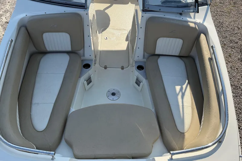 Slide: The Image of 2019 Stingray 201 DS boat interior with beige and white seating. - 17