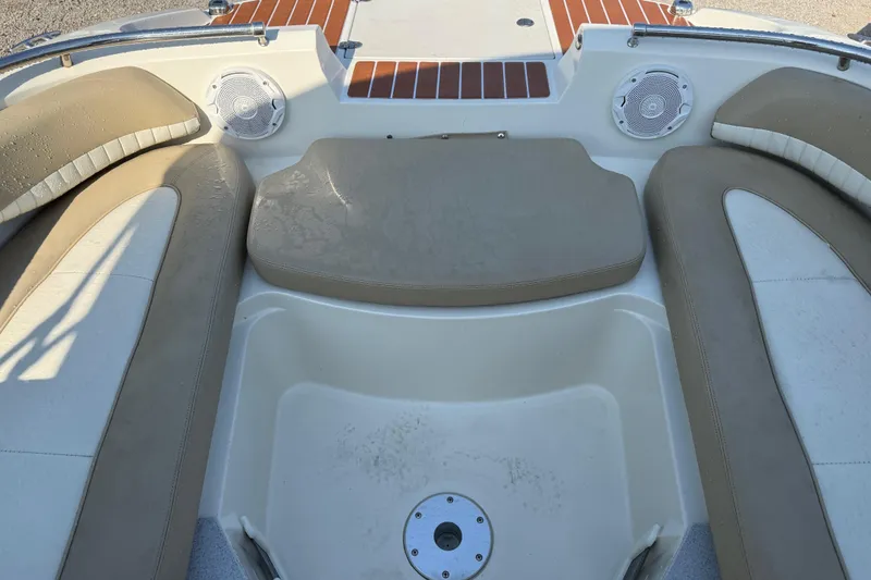 Slide: The Image of 2019 Stingray 201 DS boat interior with beige seating and speakers. - 19