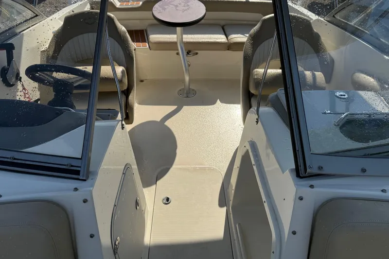 Slide: The Image of Interior view of a 2019 Stingray 201 DS boat with seating and table. - 20