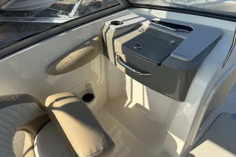 Slide: The Image of Interior of a 2019 Stingray 201 DS boat with seating and storage compartments. - 25