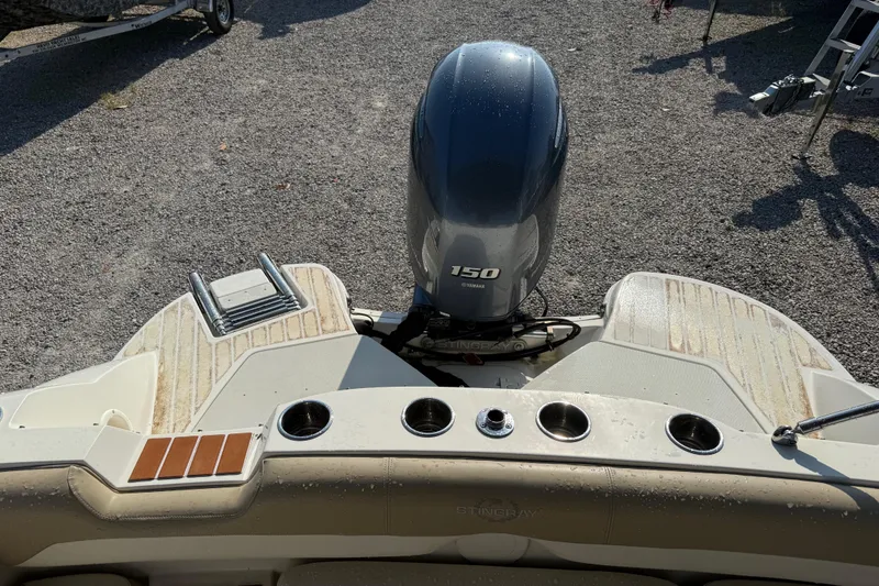 Slide: The Image of 2019 Stingray 201 DS boat with Yamaha 150 engine, rear view on gravel surface. - 26