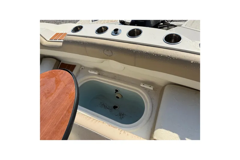 Slide: The Image of 2019 Stingray 201 DS boat interior with cup holders and storage compartment. - 28