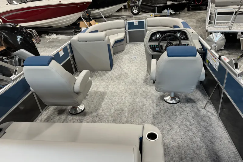 Slide: The Image of 2026 Berkshire 24 UL pontoon boat interior with plush seating and modern dashboard. - 12