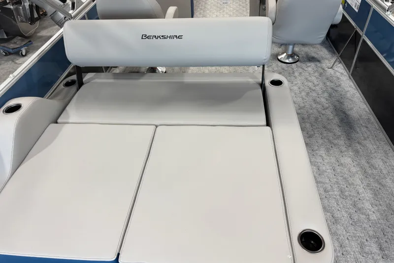 Slide: The Image of 2026 Berkshire 24 UL boat interior with cushioned seating and cup holders. - 6