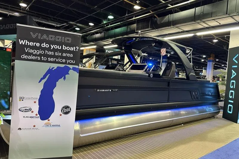 Slide: The Image of 2026 Viaggio Diamante UWA boat displayed at an indoor exhibition with dealer information. - 6