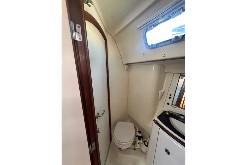 Slide: The Image of Engine compartment of a 2001 Beneteau Oceanis 473 sailboat, showing hoses and mechanical components. - 103