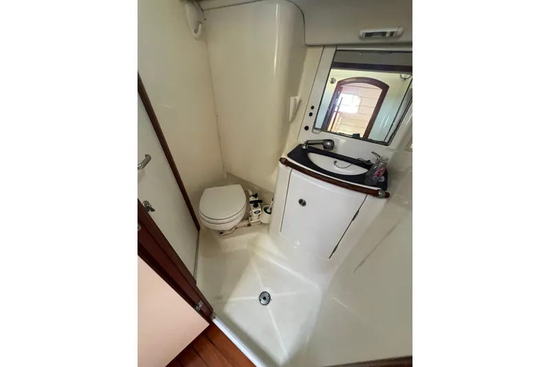 Slide: The Image of Battery compartment of a 2001 Beneteau Oceanis 473 with cables and containers. - 105