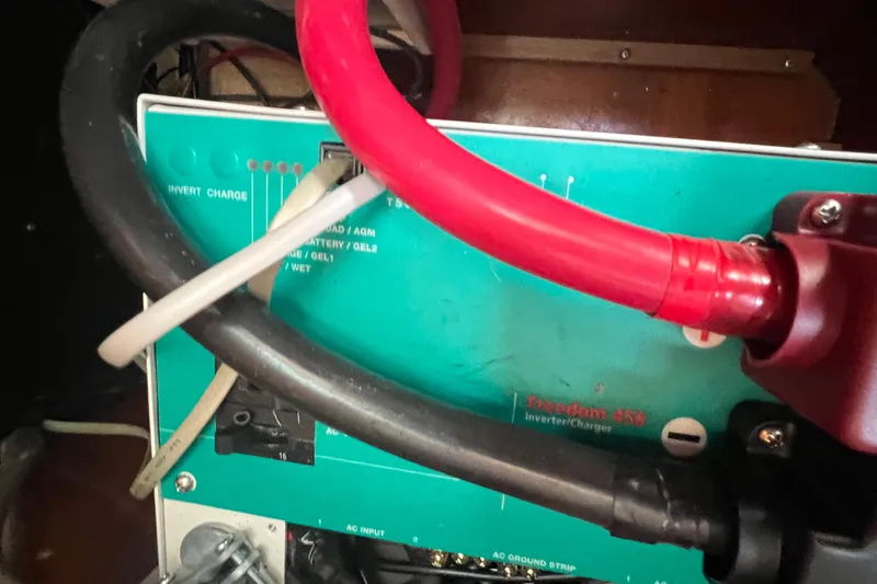 Slide: The Image of Engine compartment of a 2001 Beneteau Oceanis 473 sailboat, showing hoses and mechanical components. - 107