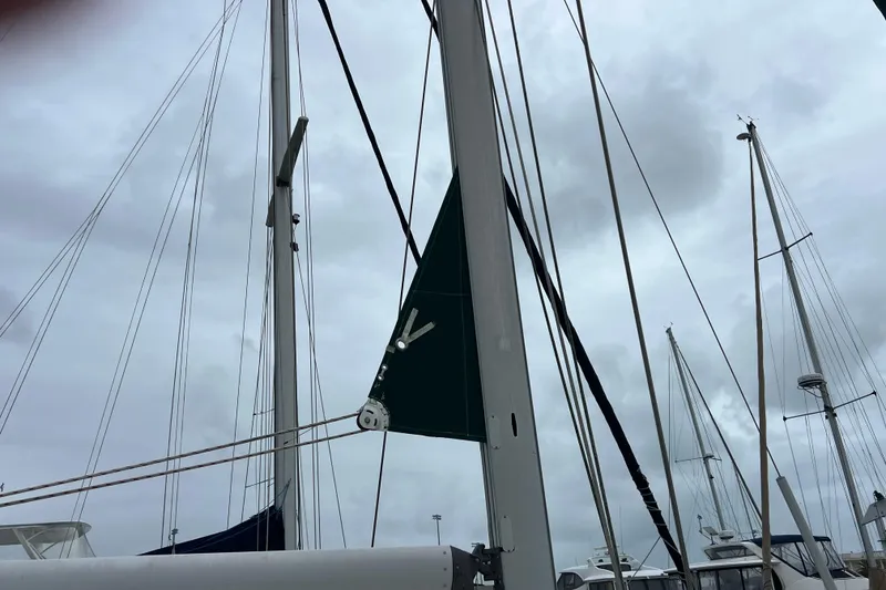 Slide: The Image of Beneteau Oceanis 473 sailboat, 2001 model, docked with green canopy and wind turbine. - 11