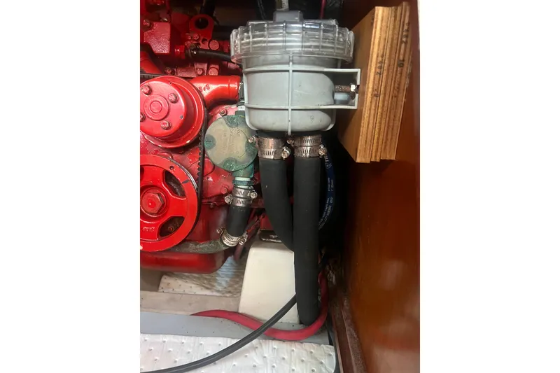 Slide: The Image of Engine of a 2001 Beneteau Oceanis 473 sailboat, showcasing red components and belts. - 112