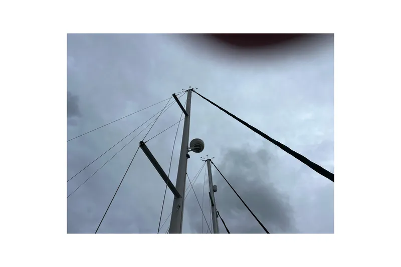 Slide: The Image of 2001 Beneteau Oceanis 473 sailboat docked at marina under clear blue sky. - 13