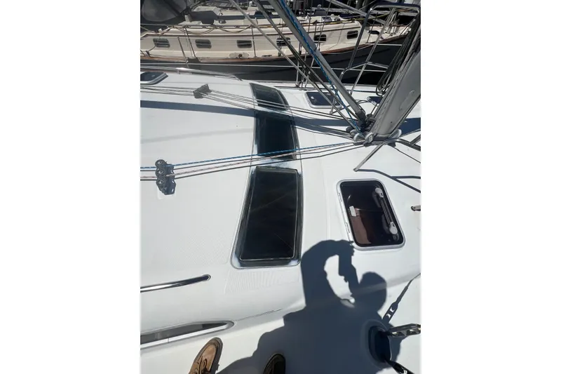 Slide: The Image of Sailboat Beneteau Oceanis 473, 2001 model, docked with green canopy and wind turbine. - 17