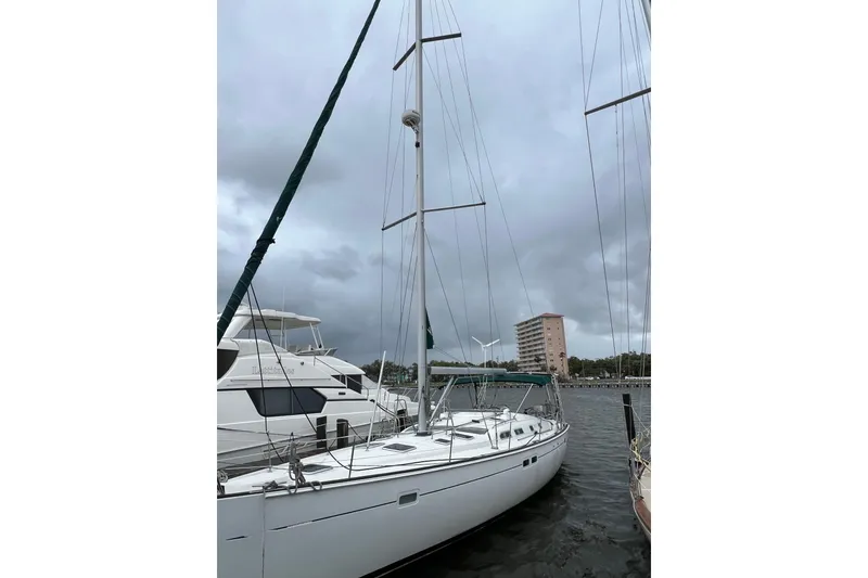 Slide: The Image of 2001 Beneteau Oceanis 473 sailboat docked at marina, front view. - 2