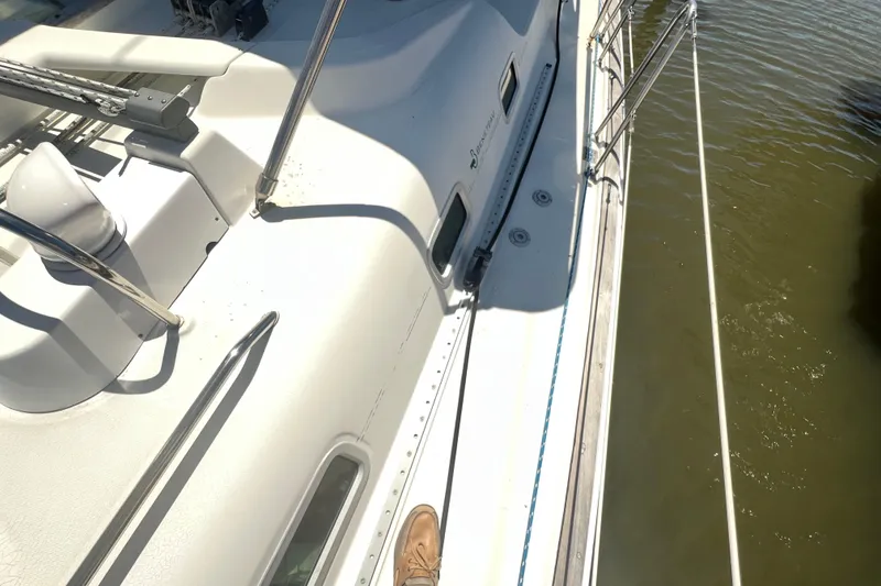 Slide: The Image of 2001 Beneteau Oceanis 473 sailboat cockpit with steering wheel and deck details. - 28