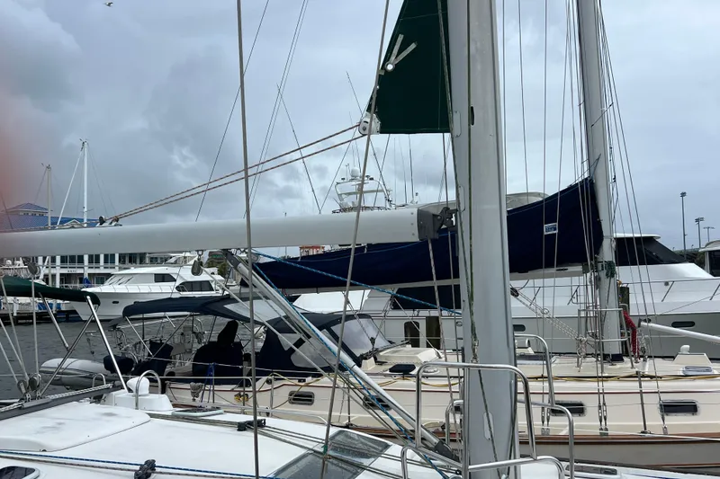 Slide: The Image of Beneteau Oceanis 473 sailboat, 2001 model, docked with green canopy, overcast sky. - 4