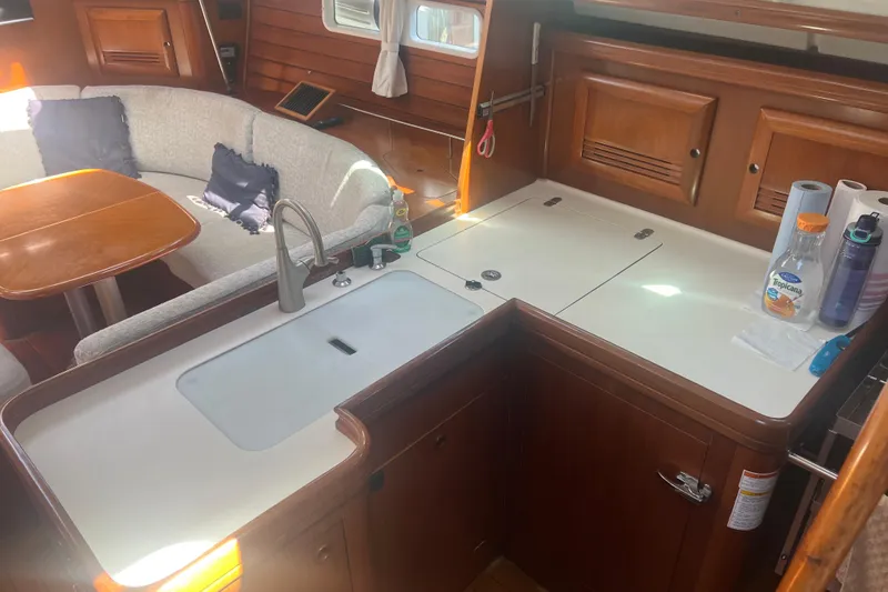 Slide: The Image of Interior of 2001 Beneteau Oceanis 473 yacht, featuring elegant wood paneling and modern amenities. - 57