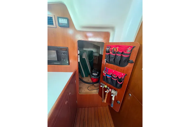 Slide: The Image of Interior view of 2001 Beneteau Oceanis 473 sailboat with skylights and wooden accents. - 62