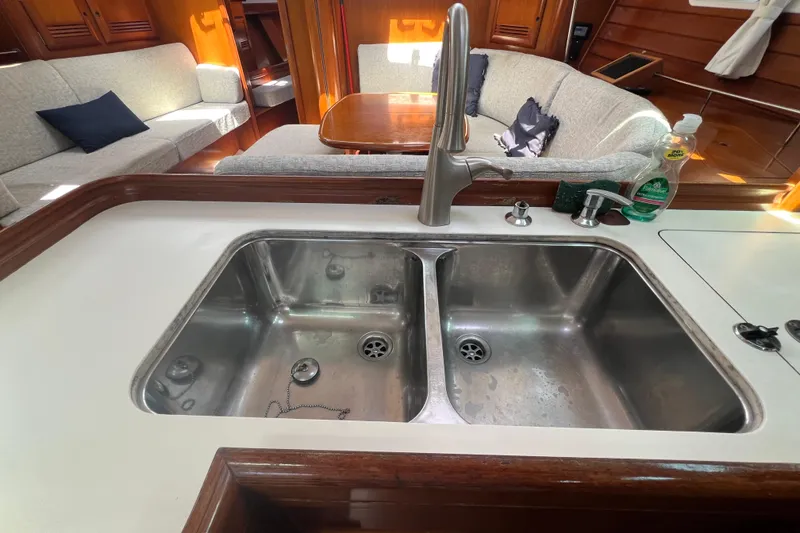 Slide: The Image of Interior view of 2001 Beneteau Oceanis 473 sailboat cabin with skylight and wooden accents. - 65