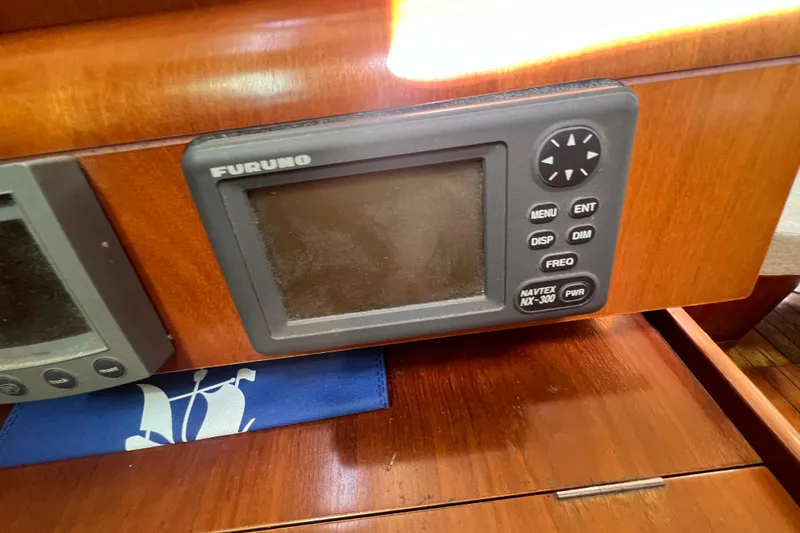 Slide: The Image of Cozy kitchen area in a 2001 Beneteau Oceanis 473 sailboat with wood cabinetry and appliances. - 69