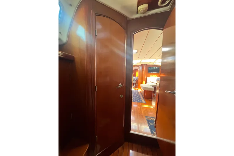 Slide: The Image of Open refrigerator inside 2001 Beneteau Oceanis 473 yacht, showcasing wooden interior and flooring. - 75