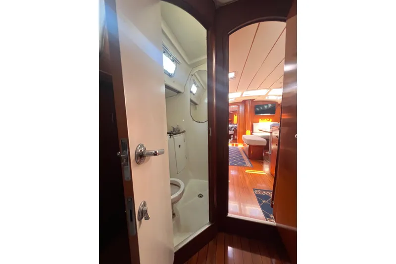 Slide: The Image of Interior of 2001 Beneteau Oceanis 473 yacht featuring a dual sink and cozy seating area. - 76