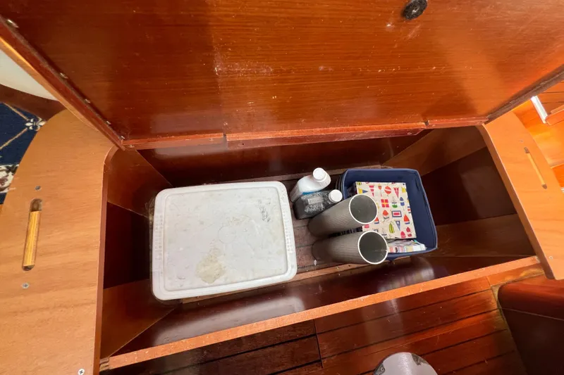 Slide: The Image of Cozy cabin interior of 2001 Beneteau Oceanis 473 sailboat with cushions and storage. - 81