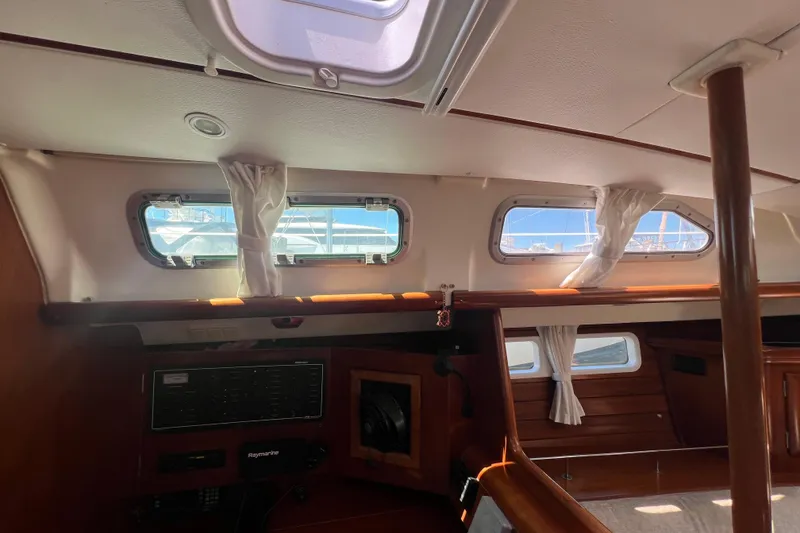 Slide: The Image of Cozy cabin interior of 2001 Beneteau 473 sailboat with plaid bedding and wooden finish. - 89