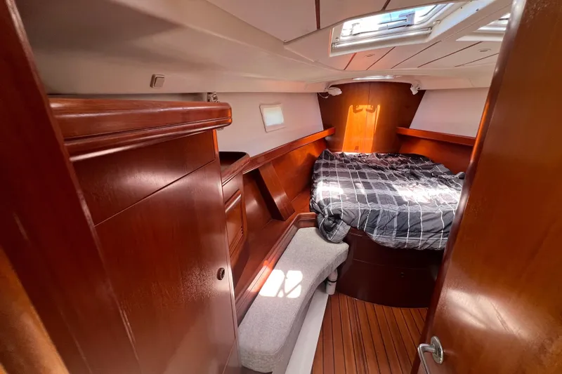 Slide: The Image of Interior of 2001 Beneteau 473 yacht with wooden paneling and cushioned seating. - 92