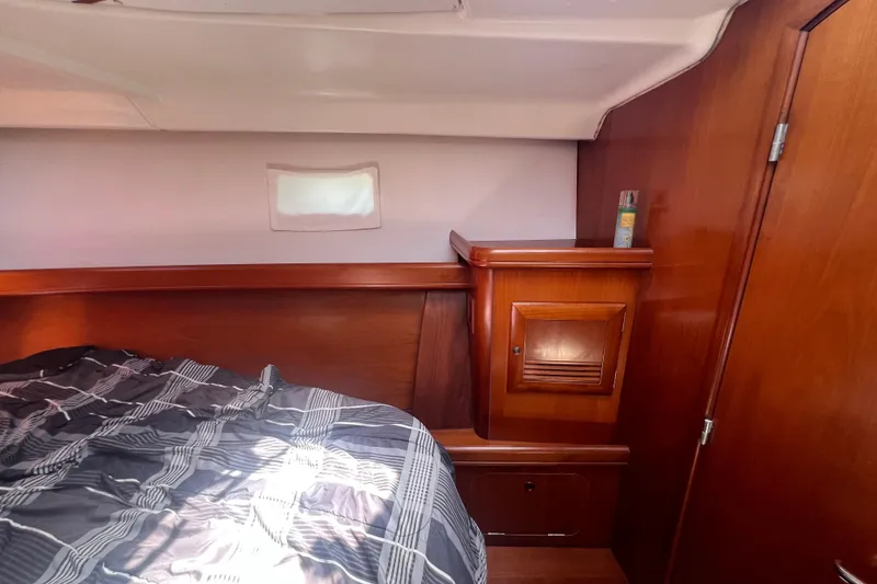 Slide: The Image of Interior of 2001 Beneteau Oceanis 473 yacht with wooden cabinetry and seating area. - 94