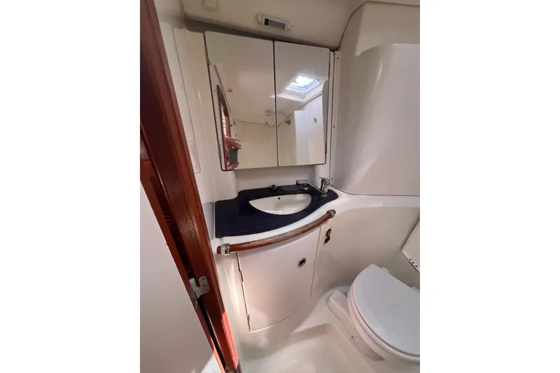 Slide: The Image of Bathroom interior of 2001 Beneteau Oceanis 473 yacht, featuring toilet and sink. - 99