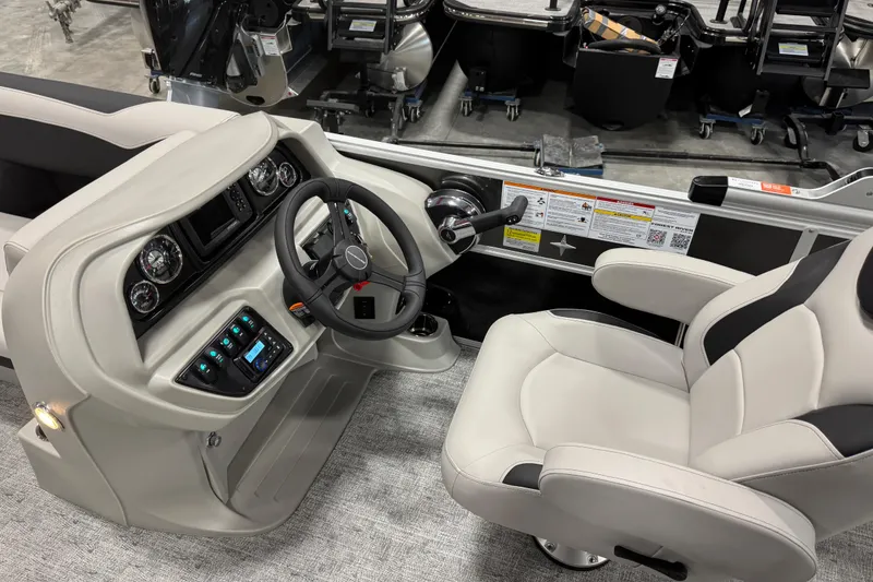 Slide: The Image of Captain's seat and helm of 2026 Berkshire 24 UL LE boat, featuring modern controls and gauges. - 11